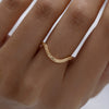 Curved-Geometric-Pattern-Gold-Wedding-Band-On-Hand-Angle