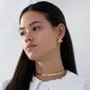 Gilded-Cage-Fan-Earrings-with-Pearl-Accent-On-Model-Far-Shot