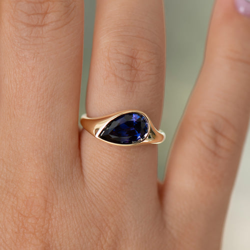 Pear-Shape-Sapphire-Solitaire-Ring-in-Violet-Purple-On-Hand-Closeup