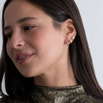 Puffy-Solid-Gold-Huggie-Earrings-On-Model