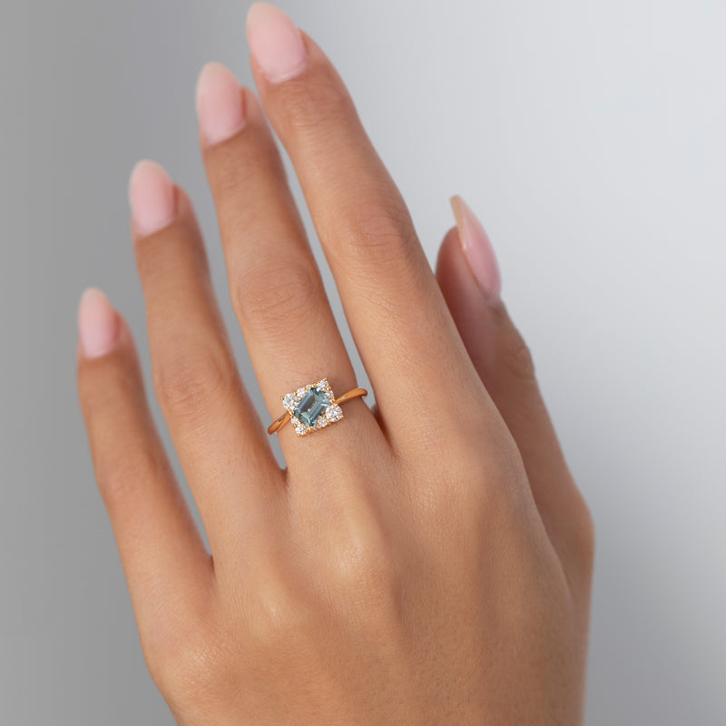 Tilted-Sky-Blue-Sapphire-Ring-with-Diamond-Frame-Far-Shot