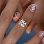 Tilted-Sky-Blue-Sapphire-Ring-with-Diamond-Frame-Holding